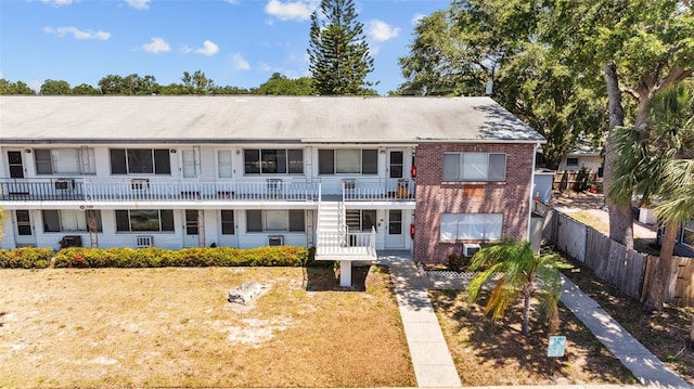 2366 Shelley St Unit 7, Clearwater, FL 33765 - back of house featuring brick siding, fence, and stairway