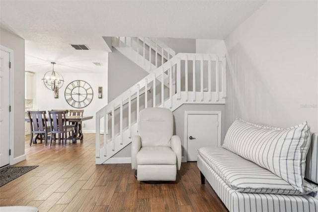 12736 Wood Trail Blvd, Tampa, FL 33625 - living area with an inviting chandelier, baseboards, wood finished floors, visible vents, and stairway