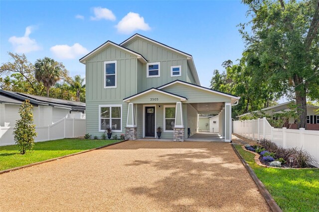 3505 N Dartmouth Ave, Tampa, FL 33603 - craftsman house with driveway, stone siding, board and batten siding, a front yard, and fence