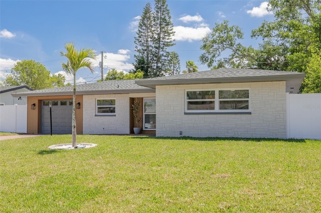 1717 Thames St, Clearwater, FL 33755 - ranch-style home with a front yard, an attached garage, fence, concrete driveway, and roof with shingles