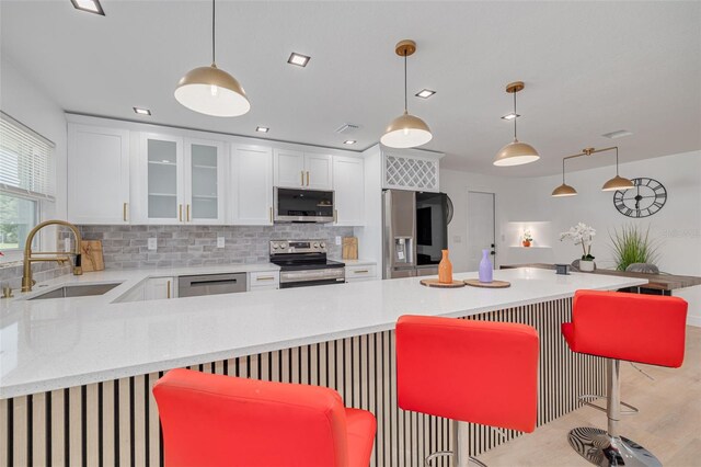 1717 Thames St, Clearwater, FL 33755 - kitchen with a sink, backsplash, appliances with stainless steel finishes, and white cabinetry