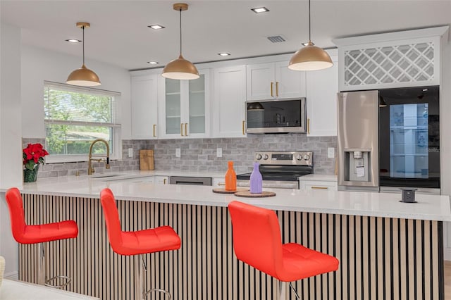 1717 Thames St, Clearwater, FL 33755 - kitchen with stainless steel appliances, glass insert cabinets, a sink, and backsplash