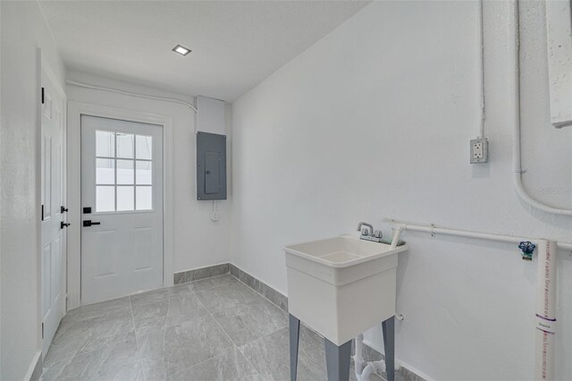 1717 Thames St, Clearwater, FL 33755 - doorway with electric panel, baseboards, and a sink
