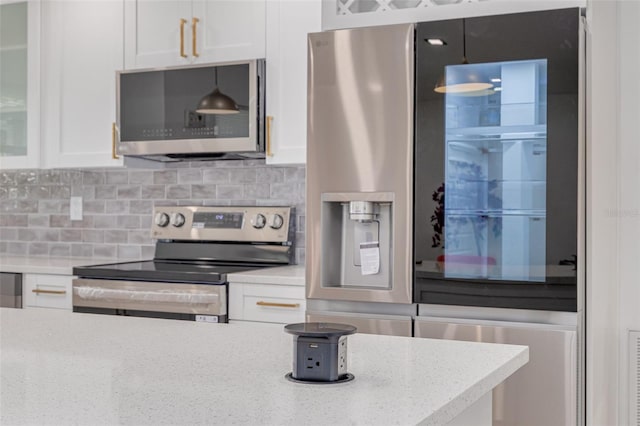 1717 Thames St, Clearwater, FL 33755 - kitchen featuring glass insert cabinets, white cabinetry, appliances with stainless steel finishes, light stone counters, and decorative backsplash