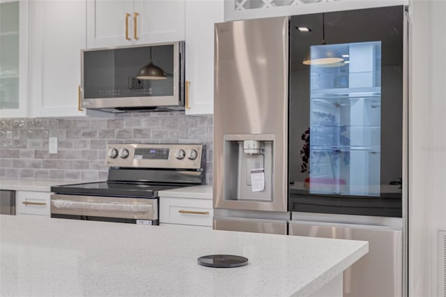 1717 Thames St, Clearwater, FL 33755 - kitchen with glass insert cabinets, white cabinets, appliances with stainless steel finishes, light stone countertops, and decorative backsplash