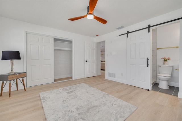 1717 Thames St, Clearwater, FL 33755 - bedroom featuring a barn door, visible vents, and light wood-type flooring