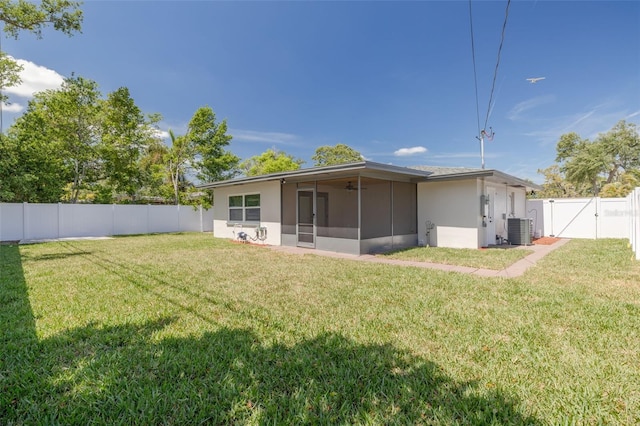 1717 Thames St, Clearwater, FL 33755 - back of house with a gate, cooling unit, a fenced backyard, a sunroom, and a lawn
