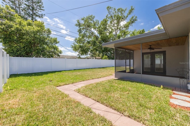 1717 Thames St, Clearwater, FL 33755 - view of yard featuring a sunroom, french doors, a fenced backyard, and a ceiling fan