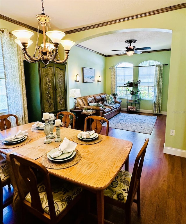 8202 Pinewood Run Ct, Tampa, FL 33647 - dining area featuring crown molding, arched walkways, dark wood finished floors, a chandelier, and baseboards