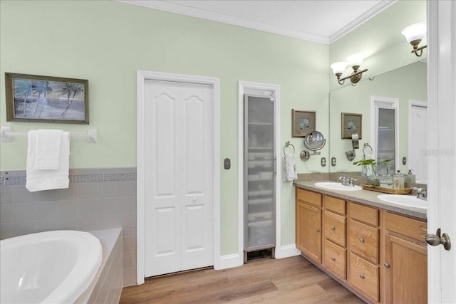 8202 Pinewood Run Ct, Tampa, FL 33647 - full bath featuring ornamental molding, a garden tub, double vanity, wood finished floors, and a closet