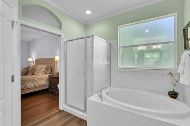8202 Pinewood Run Ct, Tampa, FL 33647 - bathroom with a bath, a shower stall, ornamental molding, ensuite bathroom, and wood finished floors
