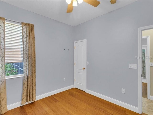 8202 Pinewood Run Ct, Tampa, FL 33647 - unfurnished bedroom with wood finished floors, baseboards, and ceiling fan