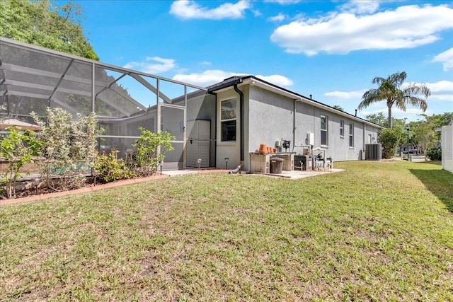 8202 Pinewood Run Ct, Tampa, FL 33647 - back of property featuring stucco siding, a yard, cooling unit, a patio area, and a lanai