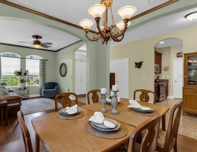 8202 Pinewood Run Ct, Tampa, FL 33647 - dining space featuring arched walkways, ornamental molding, a chandelier, baseboards, and ceiling fan