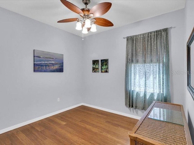 8202 Pinewood Run Ct, Tampa, FL 33647 - empty room with ceiling fan, wood finished floors, and baseboards