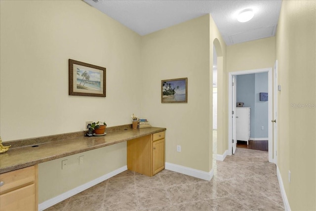 8202 Pinewood Run Ct, Tampa, FL 33647 - unfurnished office with light tile patterned floors, arched walkways, and baseboards