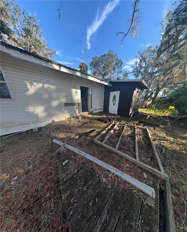318 N 4th Ave, Wauchula, FL 33873 - rear view of property featuring a vegetable garden