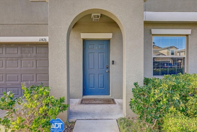 11476 Sage Canyon Dr, Riverview, FL 33578 - property entrance with a garage and stucco siding