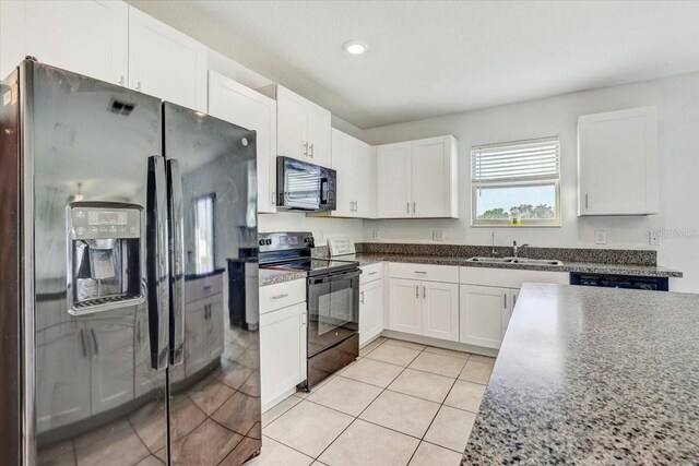 11476 Sage Canyon Dr, Riverview, FL 33578 - kitchen with a sink, white cabinetry, black appliances, recessed lighting, and light tile patterned flooring