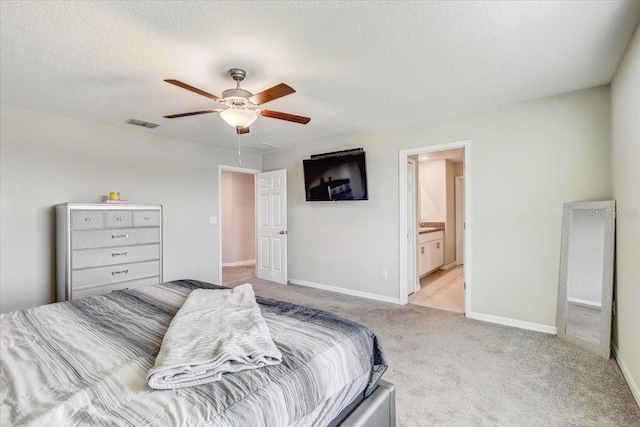 11476 Sage Canyon Dr, Riverview, FL 33578 - bedroom featuring visible vents, baseboards, a textured ceiling, connected bathroom, and light colored carpet