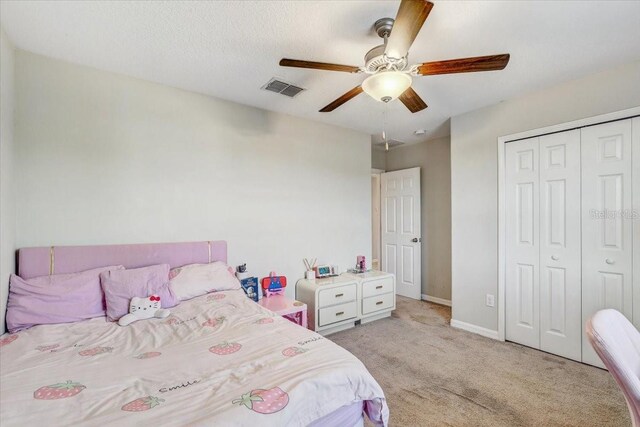 11476 Sage Canyon Dr, Riverview, FL 33578 - bedroom with a closet, baseboards, light carpet, visible vents, and ceiling fan