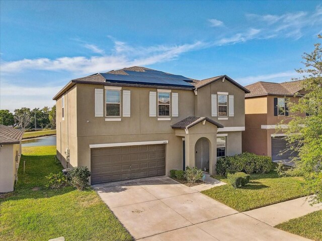 11476 Sage Canyon Dr, Riverview, FL 33578 - view of front of property with a front yard, solar panels, an attached garage, stucco siding, and driveway