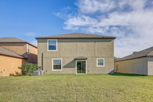 11476 Sage Canyon Dr, Riverview, FL 33578 - back of property with stucco siding, central AC unit, and a lawn