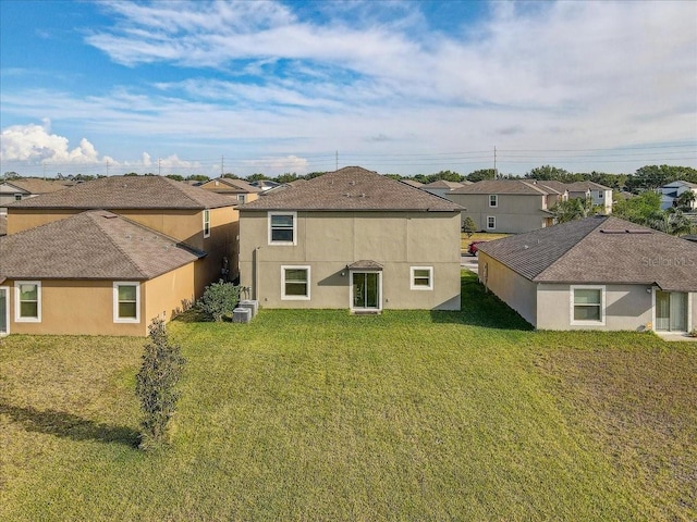 11476 Sage Canyon Dr, Riverview, FL 33578 - rear view of property featuring cooling unit, a residential view, a lawn, and stucco siding