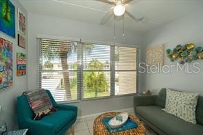 11720 Park Blvd Unit 301, Seminole, FL 33772 - living room featuring a wealth of natural light, ceiling fan, and tile patterned flooring