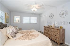 11720 Park Blvd Unit 301, Seminole, FL 33772 - bedroom featuring a closet, multiple windows, and a ceiling fan
