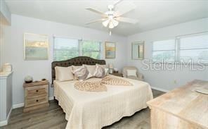 11720 Park Blvd Unit 301, Seminole, FL 33772 - bedroom featuring wood finished floors, baseboards, and a ceiling fan