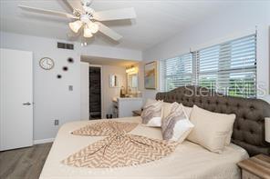 11720 Park Blvd Unit 301, Seminole, FL 33772 - bedroom with ceiling fan, visible vents, multiple windows, and wood finished floors