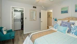 11720 Park Blvd Unit 301, Seminole, FL 33772 - bedroom featuring visible vents, a walk in closet, wood finished floors, and a ceiling fan