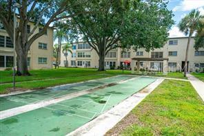11720 Park Blvd Unit 301, Seminole, FL 33772 - surrounding community featuring a yard, a residential view, and shuffleboard