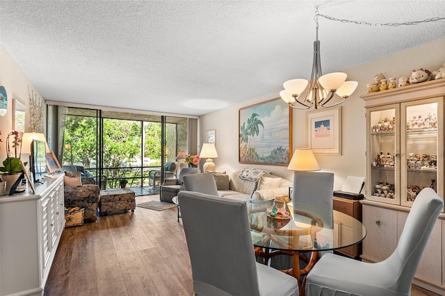 dining room with floor to ceiling windows, a chandelier, a textured ceiling, and hardwood / wood-style floors