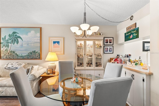 dining area with a chandelier and a textured ceiling
