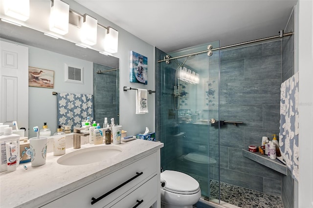 full bath with visible vents, toilet, vanity, and a stall shower