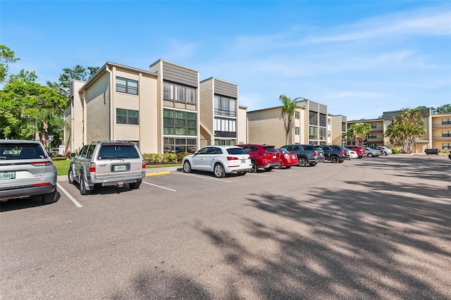 view of building exterior with uncovered parking