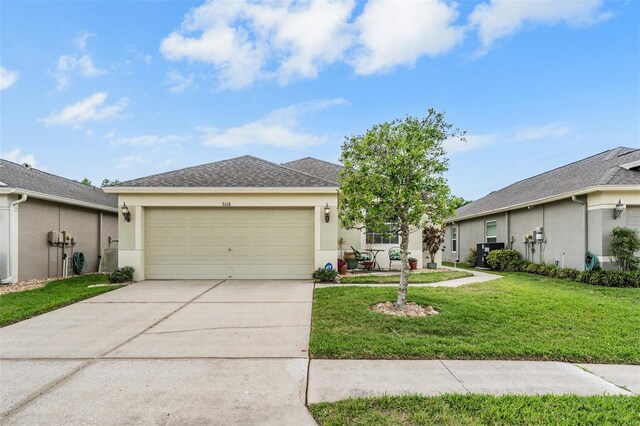 5116 Gato Del Sol Cir, Wesley Chapel, FL 33544 - view of front of home with driveway, stucco siding, an attached garage, and a front yard