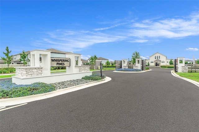 20659 Drake Elm Dr, Land O Lakes, FL 34638 - view of asphalt street featuring a gated entry, curbs, and a residential view