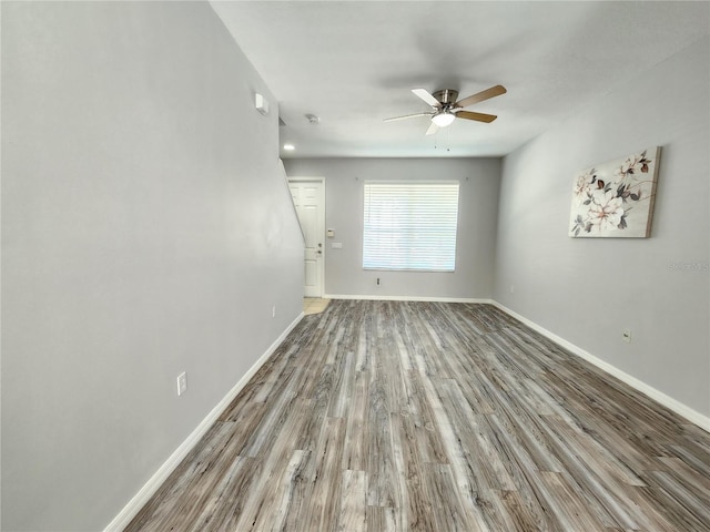 8796 Christie Dr, Largo, FL 33771 - spare room featuring a ceiling fan, wood finished floors, and baseboards
