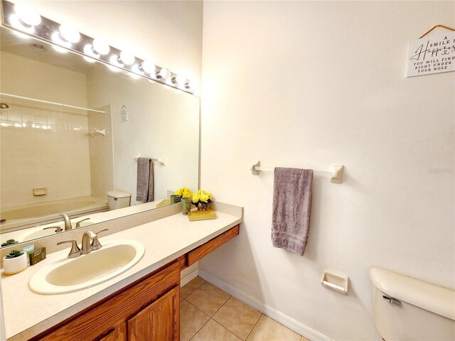 8796 Christie Dr, Largo, FL 33771 - bathroom with toilet, tile patterned flooring, vanity, tub / shower combination, and baseboards