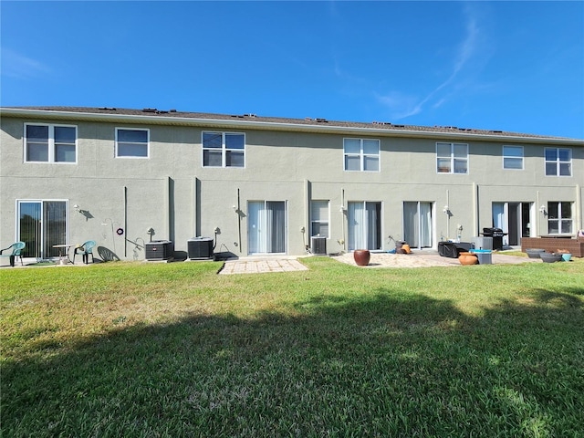 8796 Christie Dr, Largo, FL 33771 - back of property featuring cooling unit and a lawn