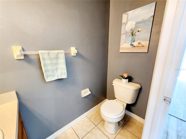 8796 Christie Dr, Largo, FL 33771 - bathroom with toilet, tile patterned floors, baseboards, and vanity