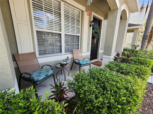 8796 Christie Dr, Largo, FL 33771 - doorway to property featuring stucco siding and a porch