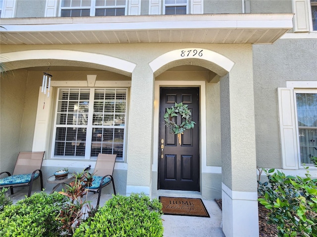 8796 Christie Dr, Largo, FL 33771 - doorway to property featuring stucco siding
