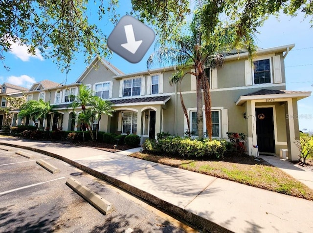 8796 Christie Dr, Largo, FL 33771 - view of property featuring stucco siding and uncovered parking