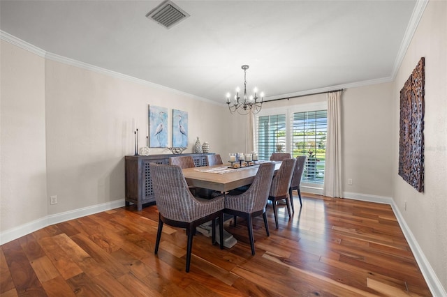 dining area featuring visible vents, an inviting chandelier, ornamental molding, and wood finished floors