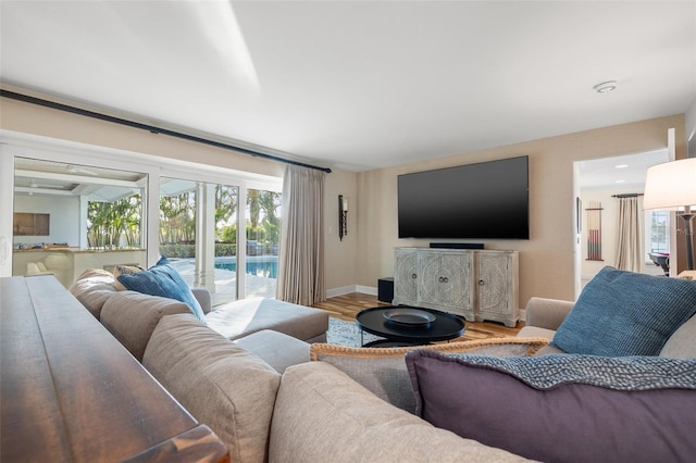 living room with baseboards and wood finished floors