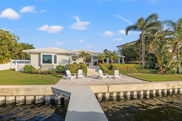 back of property featuring a patio, stucco siding, a tile roof, fence, and a lawn
